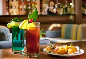 a drink and a plate of food on a table at Parco Aurora Terme in Ischia