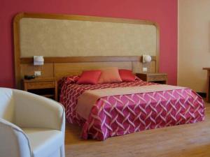 A bed or beds in a room at Leone de Castris Wine Hotel