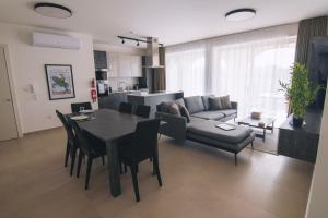 a living room with a table and a couch at The Valley Collection - Suite A10 in Xagħra