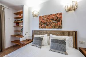 a bedroom with a white bed with two pillows at Sweet Blue in Playa Blanca