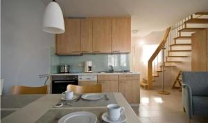 a kitchen with a table with two plates on it at Haus Blinkfüer in Wangerooge