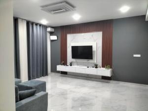 a living room with a television on a wall at NN Stayz in Negombo