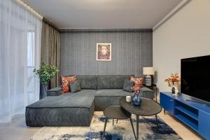 a living room with a couch and a table at Scala City Center Premium Apartments with Parking by Lion Apartments in Gdańsk