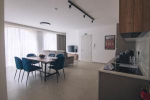 a kitchen and living room with a table and chairs at The Valley Collection - Suite B19 in Xagħra