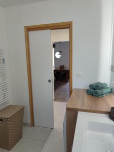 a kitchen with a door leading to a dining room at Le Relais in Fumay