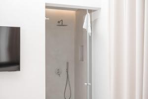 a shower in a bathroom with a shower curtain at Iodis Relais in Naples +65 photos