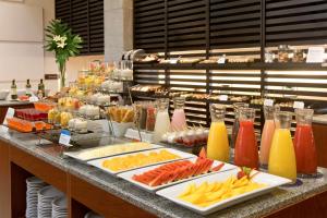 a buffet with many different types of food and drinks at NH Córdoba Panorama in Córdoba