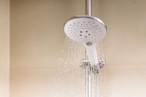 a shower head with water coming out of it at NH Córdoba Panorama in Córdoba