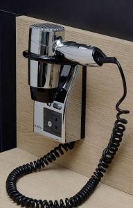 a telephone is attached to a wooden table at NH Córdoba Panorama in Córdoba