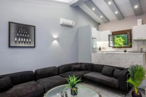 a living room with a couch and a table at Palms Jacuzzi and Pool Villa in Sani Beach