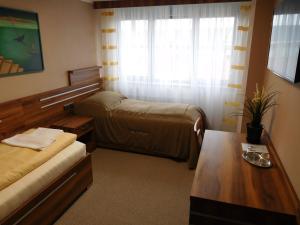 Łóżko lub łóżka w pokoju w obiekcie Hotel Panon