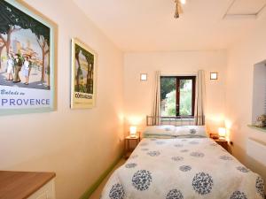 a bedroom with a bed and a window at South Lodge Cottage in Standish