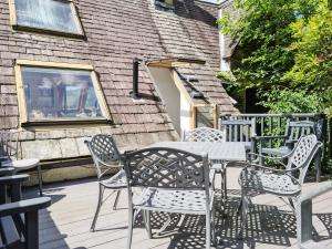 a table and chairs sitting on a deck at Newfold Cottage in Bowness-on-Windermere
