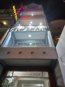a building with a sign over the entrance to a store at MAI VY Hotel in Phan Thiet