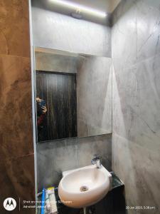 a bathroom with a sink and a mirror at Puri Inn in Varanasi +22 photos