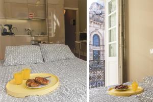 BmyGuest - Cardosas Stylish Apartment في بورتو: سرير مع صينية من الكعك وكؤوس من عصير البرتقال