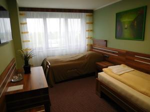 Łóżko lub łóżka w pokoju w obiekcie Hotel Panon