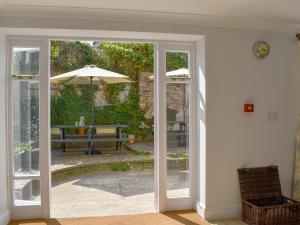 an open door to a patio with an umbrella at The Townhouse in Wimborne Minster