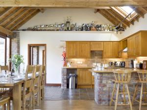 a kitchen with wooden cabinets and a stone counter top at Barley Edge in Hornsea