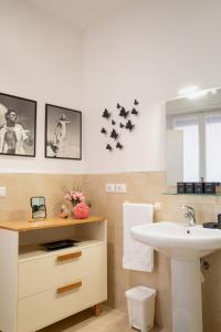 a bathroom with a sink and a toilet and a mirror at lachiocciola - Centro storico di Imola, autodromo e Formula 1 in Imola +15 photos