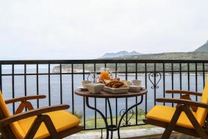 einen Tisch mit einem Teller Essen auf dem Balkon in der Unterkunft Panorama Rooms in Pyrgos Dirou