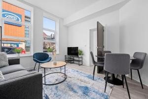 una sala de estar con un sofá y una mesa en Modern 2BD City Apartment, en Warrington