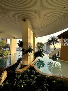 a swimming pool in a building with a swimming pool at Sky Residence in Ekkamai in Bangkok