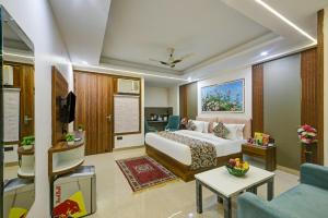 a hotel room with a bed and a living room at Hotel Dream World - Free Airport Drop in New Delhi