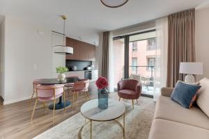 a living room with a couch and a table at Scala City Center Magic Apartments with Parking by Lion Apartments in Gdańsk