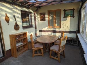 a wooden table and chairs on a patio at Pension Alte Schmiede in Greifswald