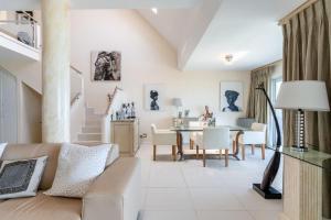 a living room with a couch and a table at Dolphin Beach Penthouse in Cape Town