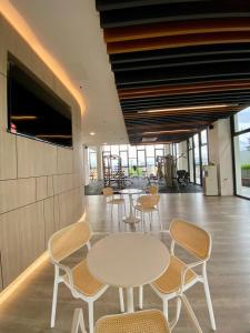 a room with tables and chairs in a building at K AVENUE B09 STUDIO king BED in Donggongon