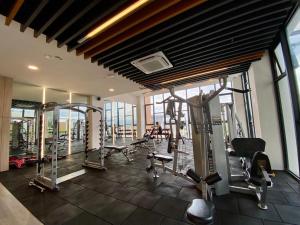 a gym with treadmills and machines in a building at K AVENUE B09 STUDIO king BED in Donggongon