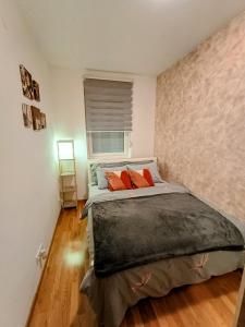 a bedroom with a large bed with orange pillows at MV Dreams, free parking in Novi Sad