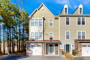a large house with two white garage doors at Creekside --- 26 Dockside Dr in Millville