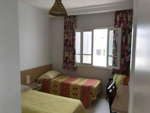 a small room with two beds and a window at La douceur de Hammamet in Yasmine +7 photos