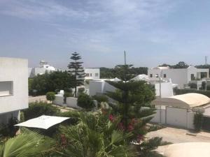 a view of a city with white buildings and trees at La douceur de Hammamet in Yasmine