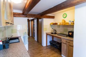 a kitchen with wooden ceilings and a counter top at Pension Hejnice in Hejnice