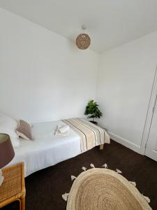 a white bedroom with a bed and a rug at Single Bedroom in Birmingham Near City Center in Birmingham +7 photos