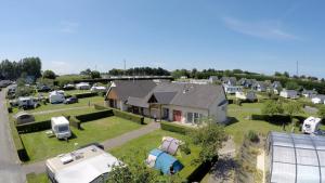 an aerial view of a house with a lot of parked vehicles at Camping Etennemare in Saint-Valery-en-Caux