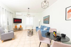 a living room with a blue couch and a table at Smart Home Corfu 3 in Potamós