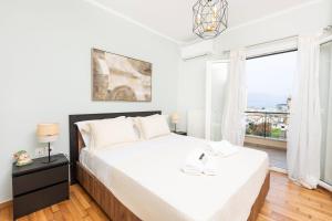 a bedroom with a bed and a large window at Smart Home Corfu 3 in Potamós