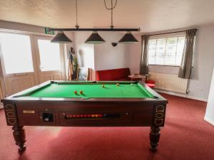 a living room with a pool table in a room at The Old Stables in Skegness