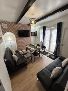a living room with a couch and a table at Spaghetti House - 6 Bedroom Contractor House Sleeps 12 Parking for 3 Vans Bromford Duddeston Fort Dunlop Star City Saltley Viaduct HS2 in Birmingham