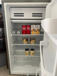 an open refrigerator filled with food and drinks at Sleep on 489 in Pretoria