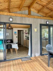 a living room with sliding glass doors and a table at Le Domaine des Pins in Saint-Hilaire-de-Riez