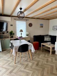 a living room with a table and a couch at Le Domaine des Pins in Saint-Hilaire-de-Riez