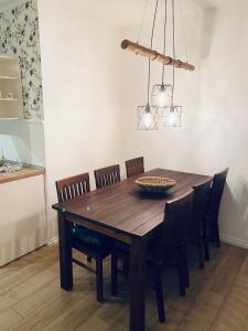 a dining room table with chairs and aendant light at Ferienwohnung Hohensonne in Aach