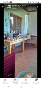 a long wooden table in a room with a mirror at House Mara in Korenica