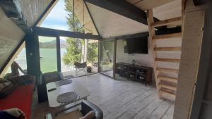 a living room with a view of the water at Colibița A-frame in Colibiţa